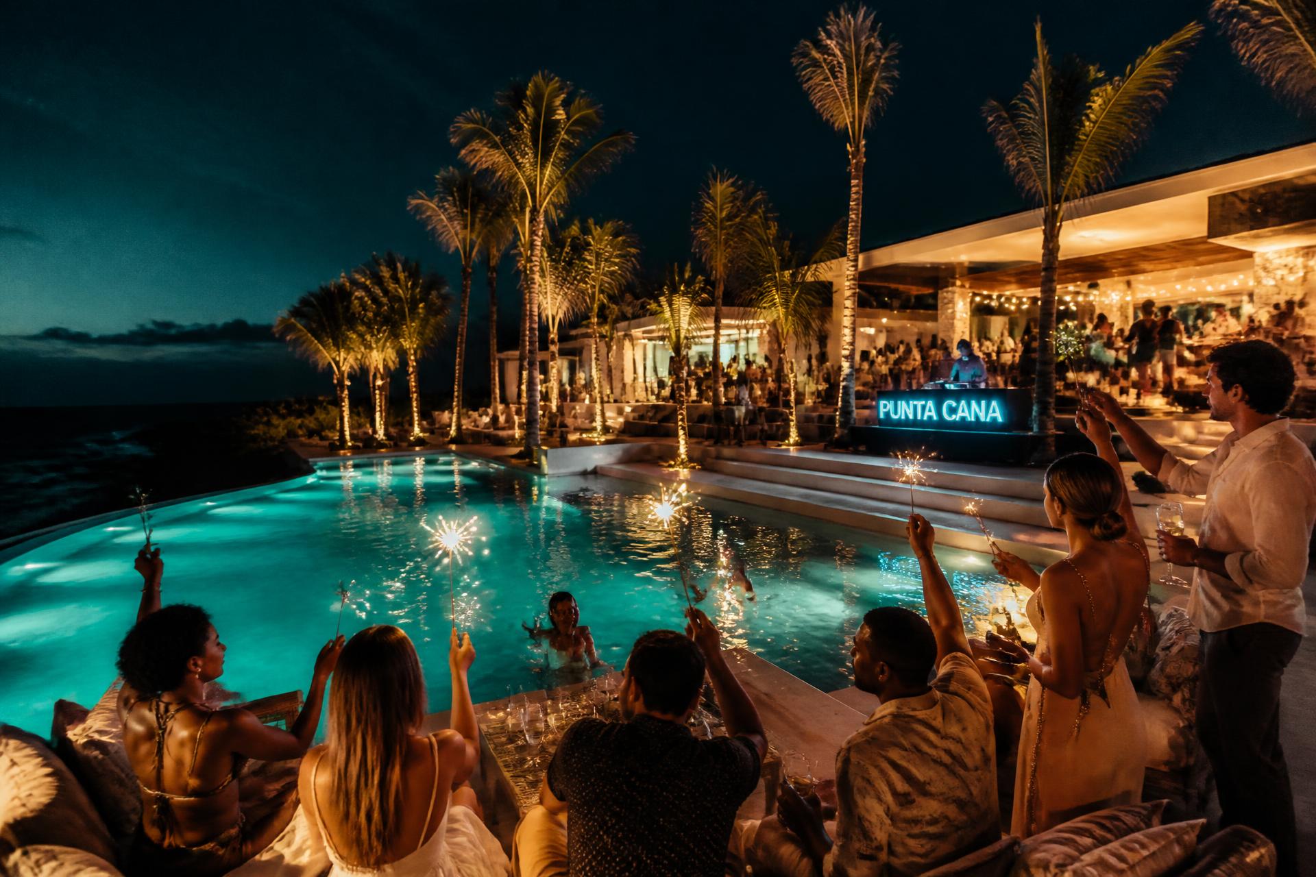 Private villa pool party at night in Punta Cana with a group celebrating